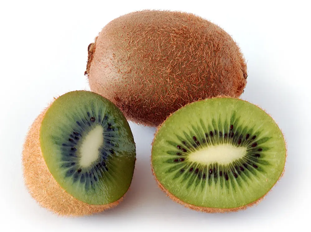 Whole and sliced kiwifruit showing green flesh and black seeds