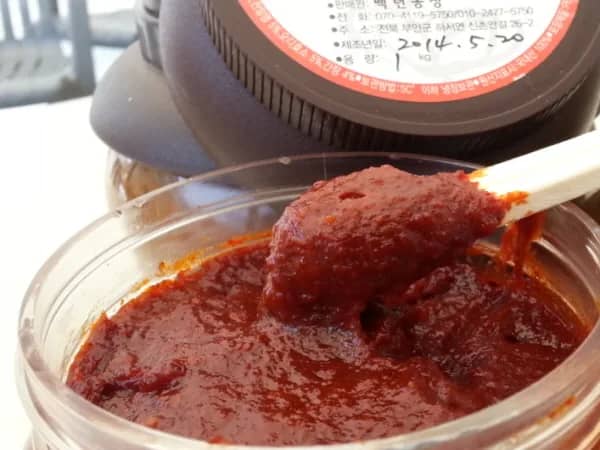 Deep red gochujang paste in a container