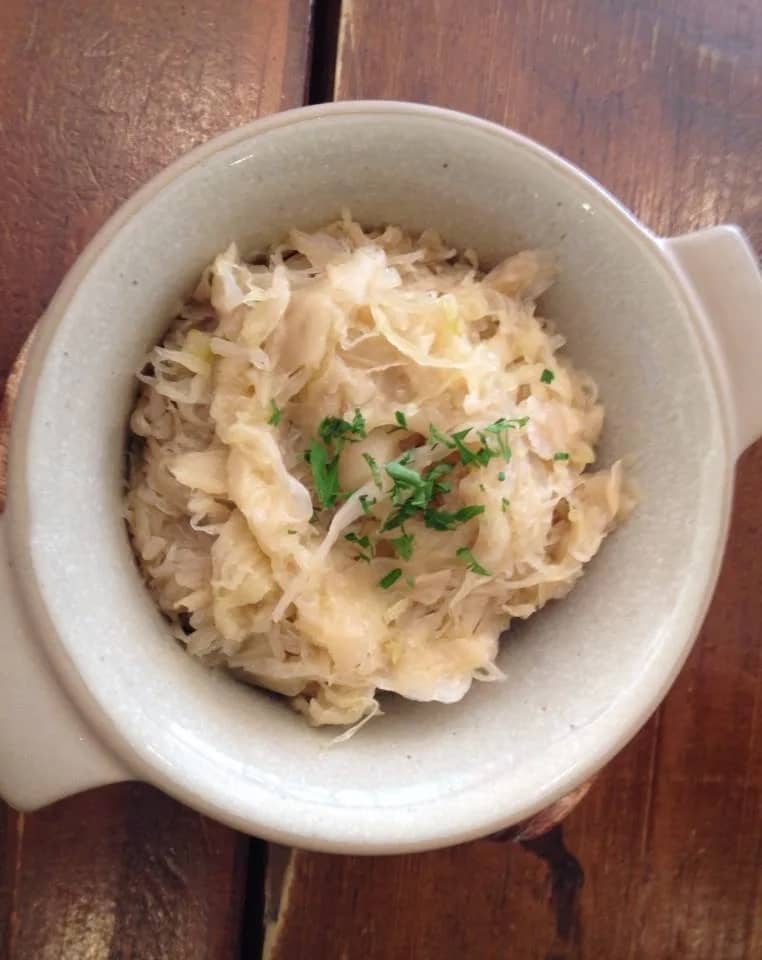 Shredded sauerkraut in a ceramic bowl