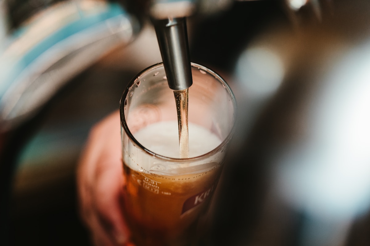 Golden beer in a glass with foam head