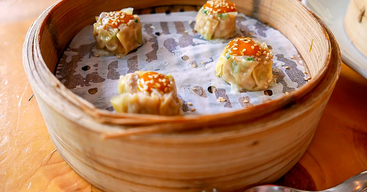 Dark Chinese black vinegar with noodles, dumplings, and rice