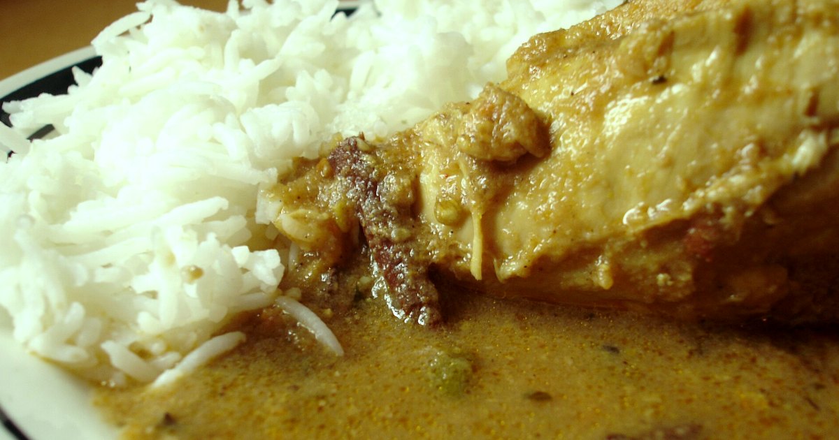 Curry ingredients and finished dish arranged in natural light