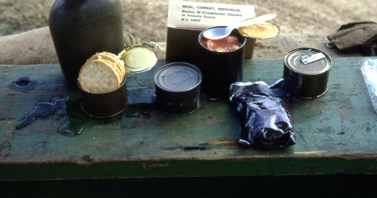 Kitchen-table photograph showing military ration and accompanying tools