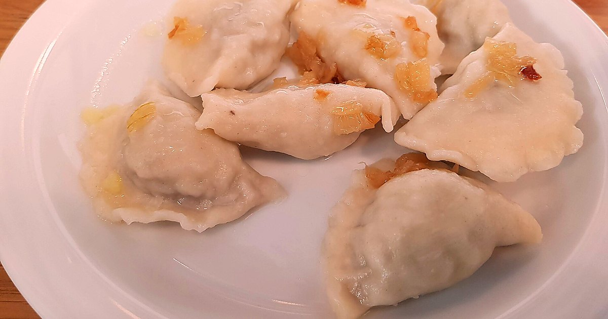 Close view of pierogi prepared for serving on a simple table