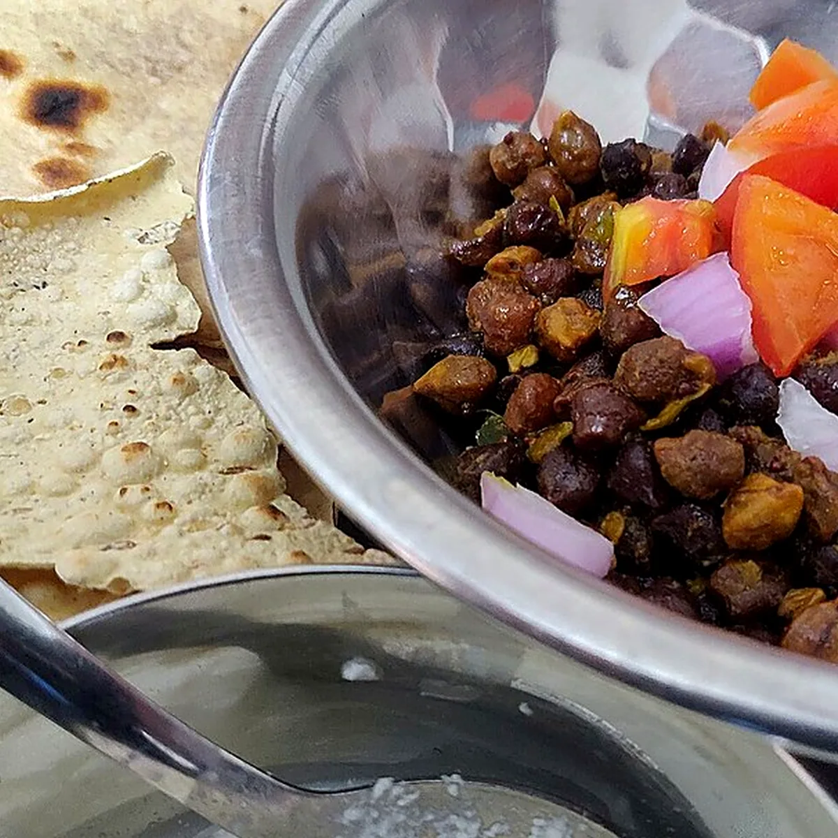 Step 2 for Chana Masala, showing the ingredients and preparation at this stage
