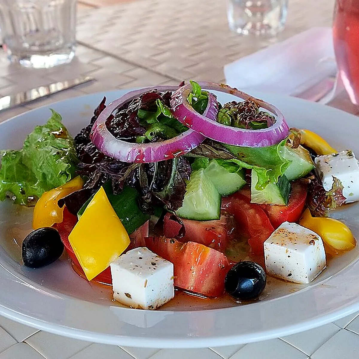 Step 1 for Greek Salad, showing the ingredients and preparation at this stage