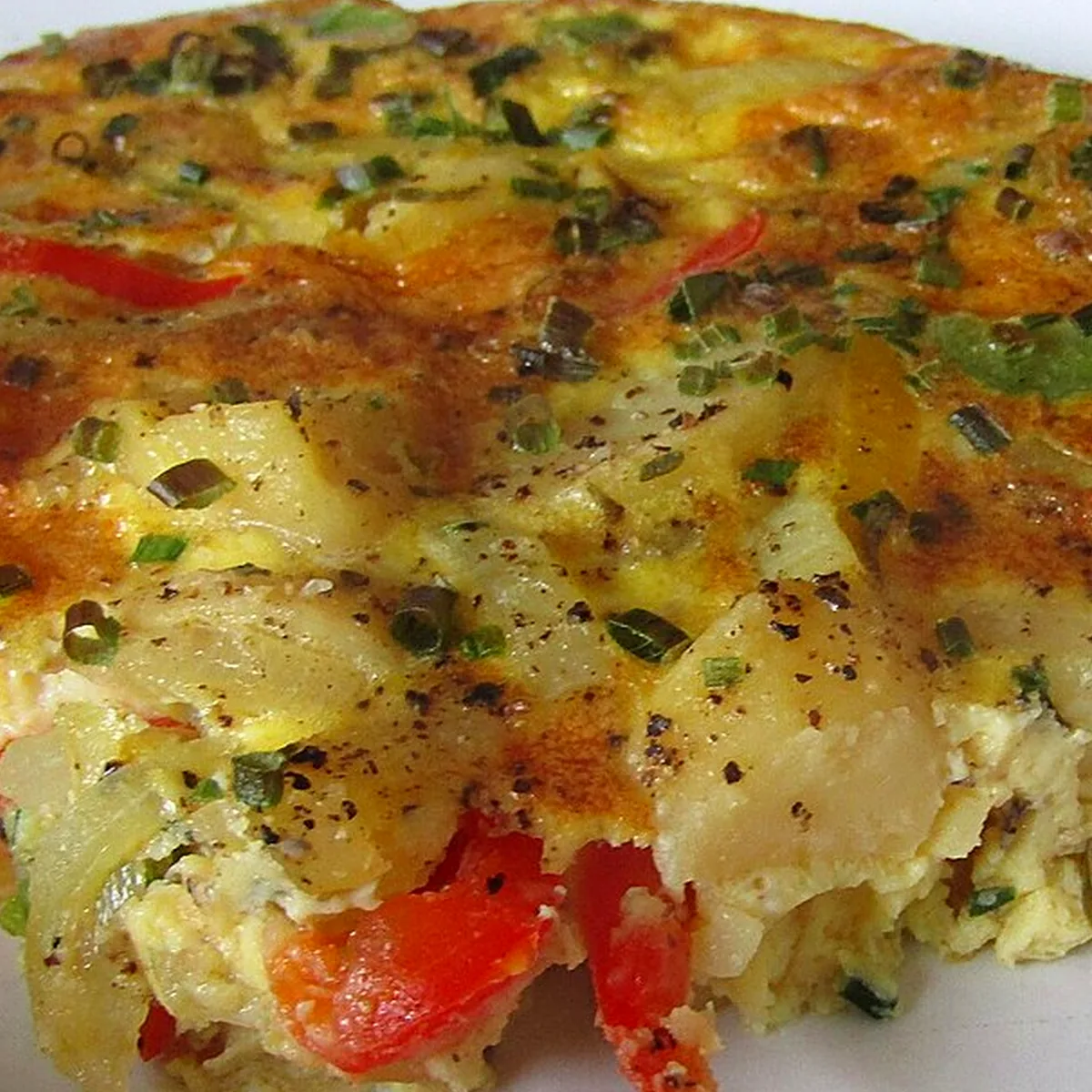 Step 2 for Tortilla Española, showing the ingredients and preparation at this stage