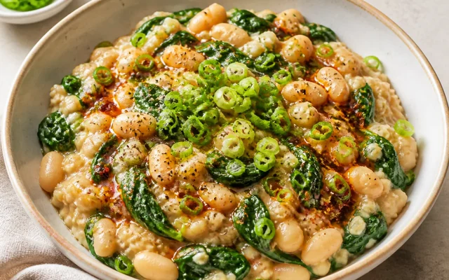 Savory Oats with White Beans and Greens, styled to show the recipe's intended texture, color, and serving presentation